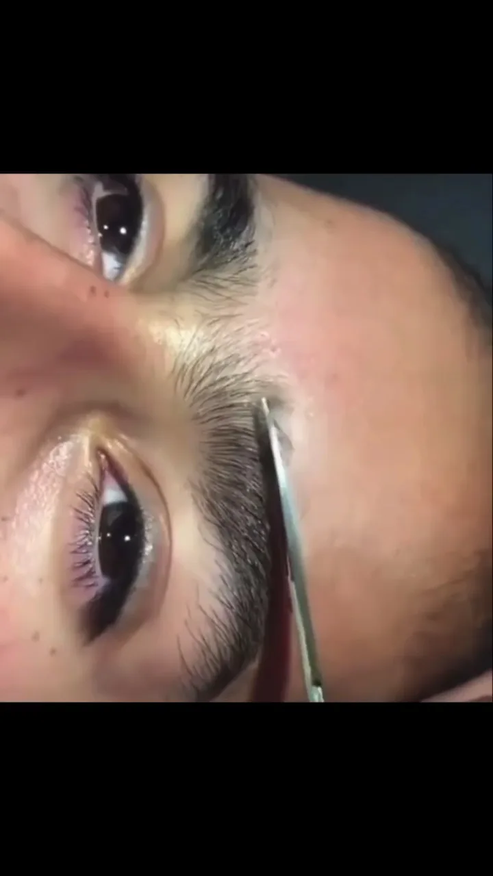 Close-up of eyebrow threading and shaping — precision brow definition